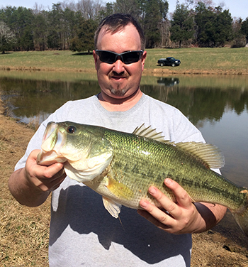 travis durrer with fish in his hands