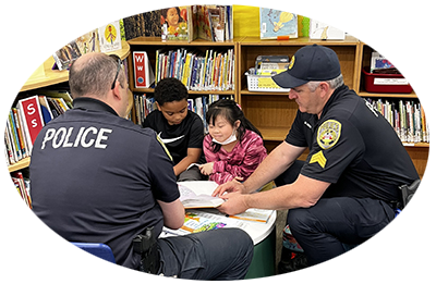 Two UPD officers working with their students